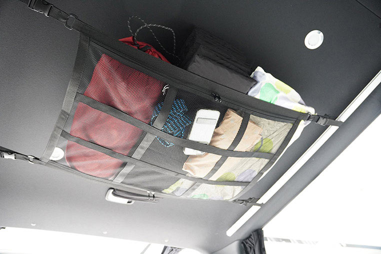 車の天井に張ったカーゴネットに荷物をたくさん収納しているイメージ